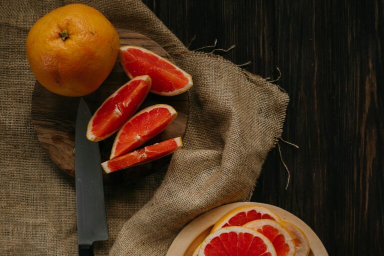 Sliced Orange Fruit on Brown Textile